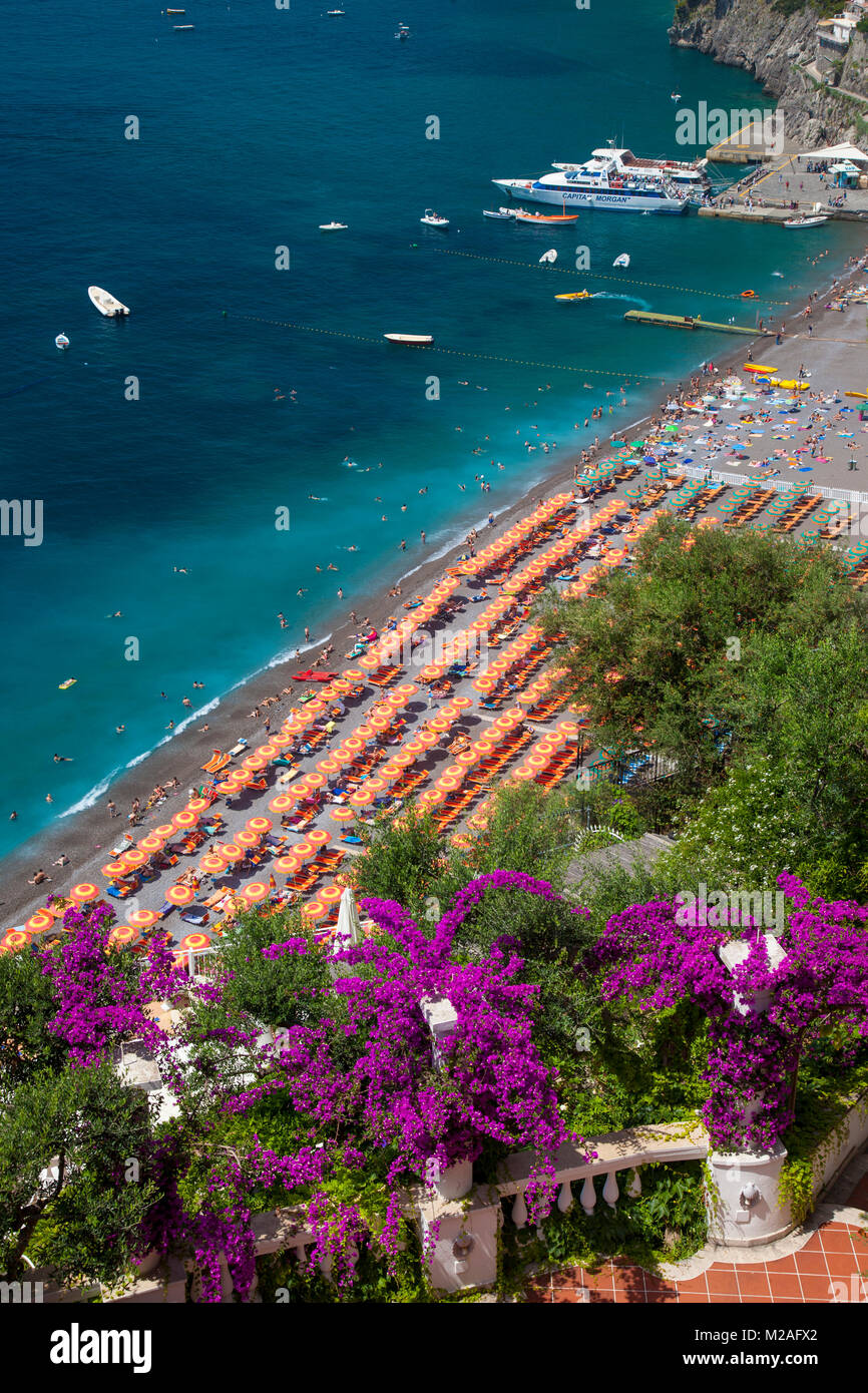Resort Hotel si affacciano sull'orange ombrelloni lungo la spiaggia di Positano, Campania, Italia Foto Stock