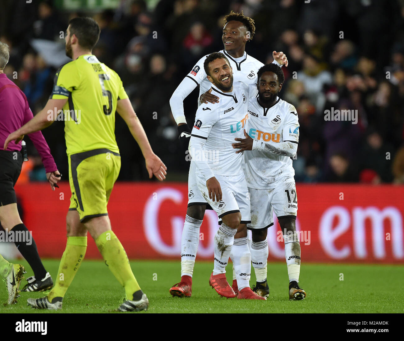 Swansea City's Wayne Routledge (sinistra) festeggia con i compagni di squadra Nathan Dyer (destra) e Tammy Abramo dopo aver segnato il suo lato è il sesto obiettivo durante la Emirates FA Cup, quarto round replay corrispondono al Liberty Stadium, Swansea. Foto Stock