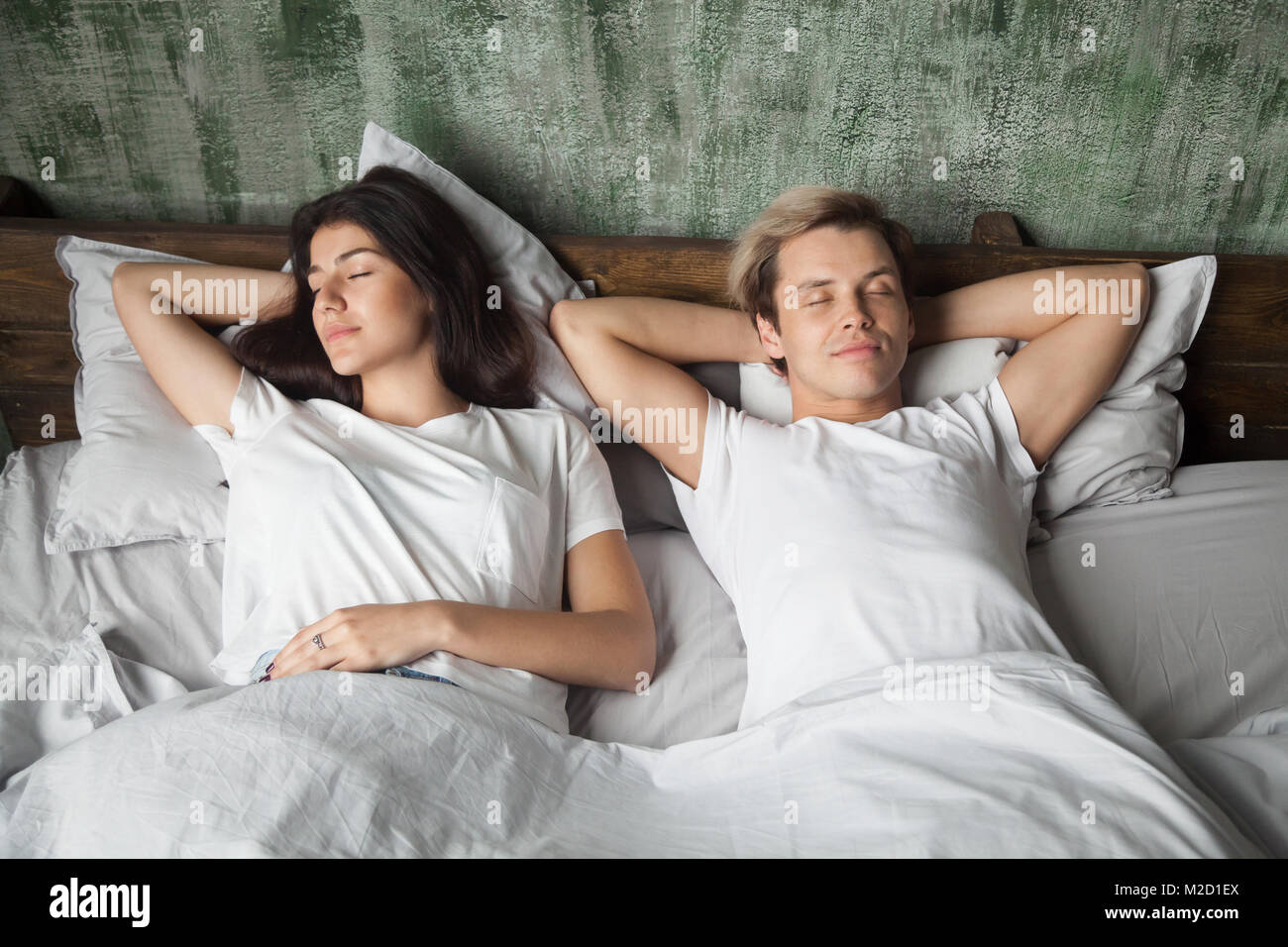 Coppia giovane appoggiato dormire bene insieme in un letto confortevole Foto Stock