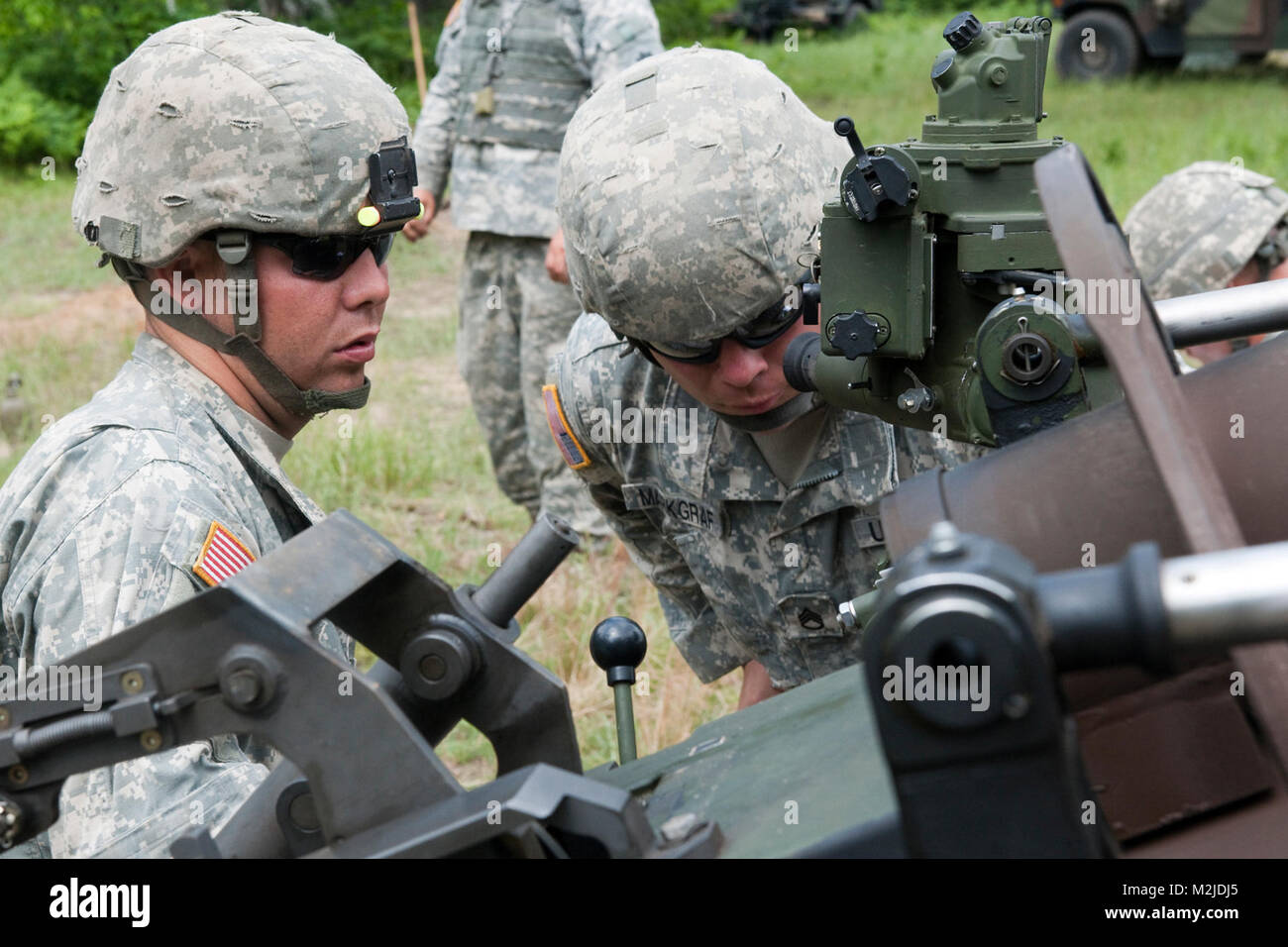 Il personale Sgt. Christopher Markgraf un residente di Mustang e un capo della sezione con batteria A, 1° Battaglione, centosessantesimo campo reggimento di artiglieria, 45th della brigata di fanteria Team di combattimento, Oklahoma, l esercito nazionale Guard controlla i siti di interesse di un M119 Obice prima di essere sparato durante un live fire esercitazione a Camp temolo, Mich Giugno 22. 1° Battaglione, centosessantesimo campo reggimento di artiglieria hanno partecipato a corsi di formazione che qualifica la unità di utilizzare la M119 Obice sostituendo le vecchie di decenni M102 obici. Markgraf è stata servendo con l'esercito Oklahoma la guardia nazionale per nove anni. (U.S. Esercito foto di Spc. Foto Stock