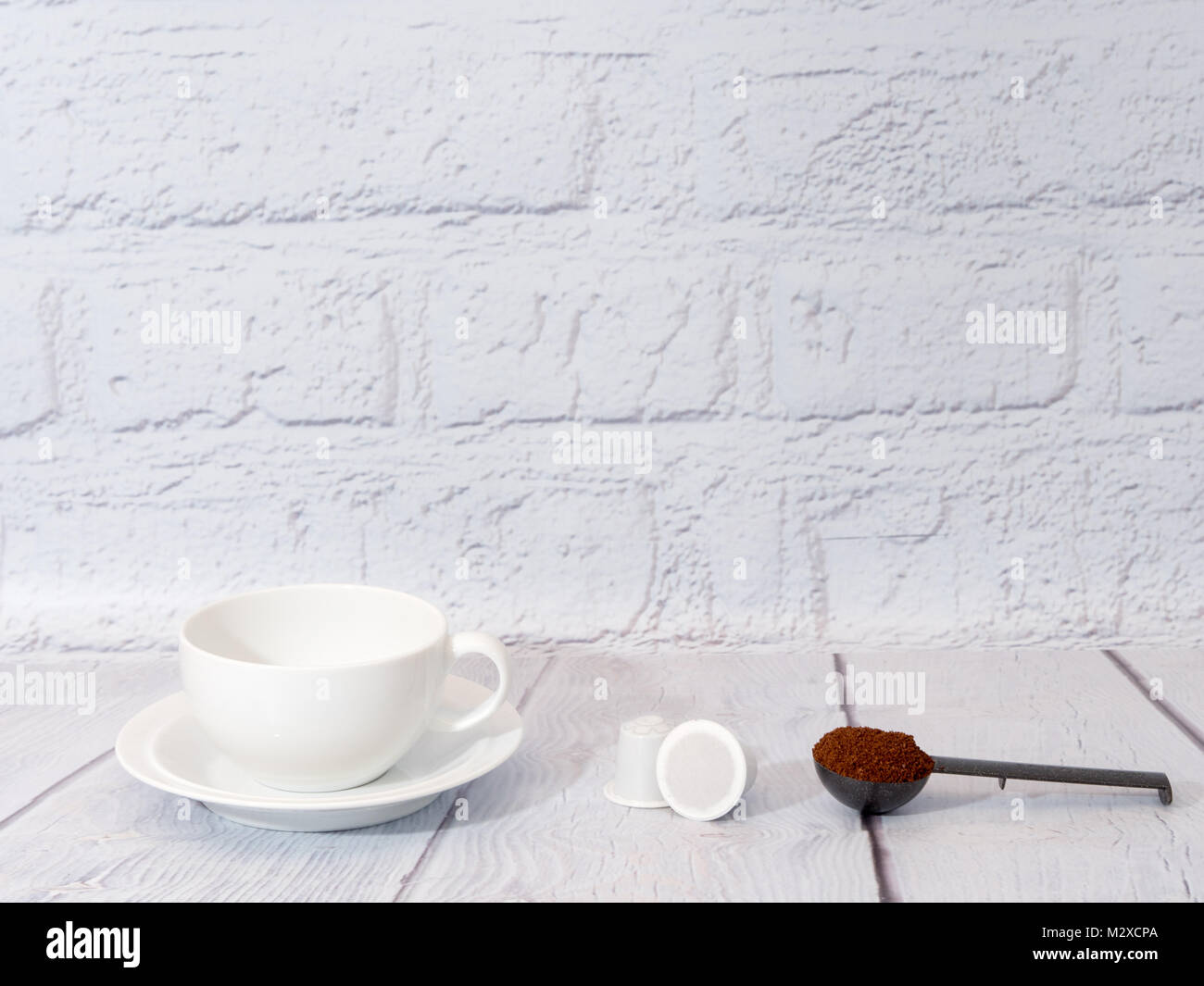 Bianco una tazza di caffè con una dose di polvere di caffè e bianco generico nespresso montare le cialde di caffè Foto Stock