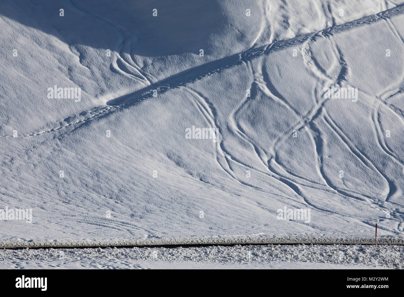 Piste da sci sulla neve su un versante alpino Foto Stock