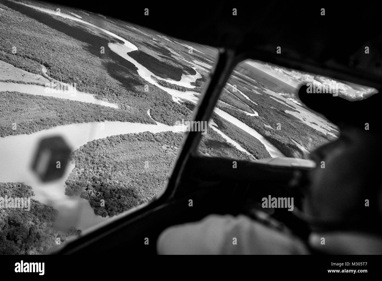 Un colombiano pilota della compagnia aerea effettua una manovra di terra un Douglas DC-3 velivolo tra i canali del fiume all'aeroporto di Barranco Minas, Colombia. Foto Stock