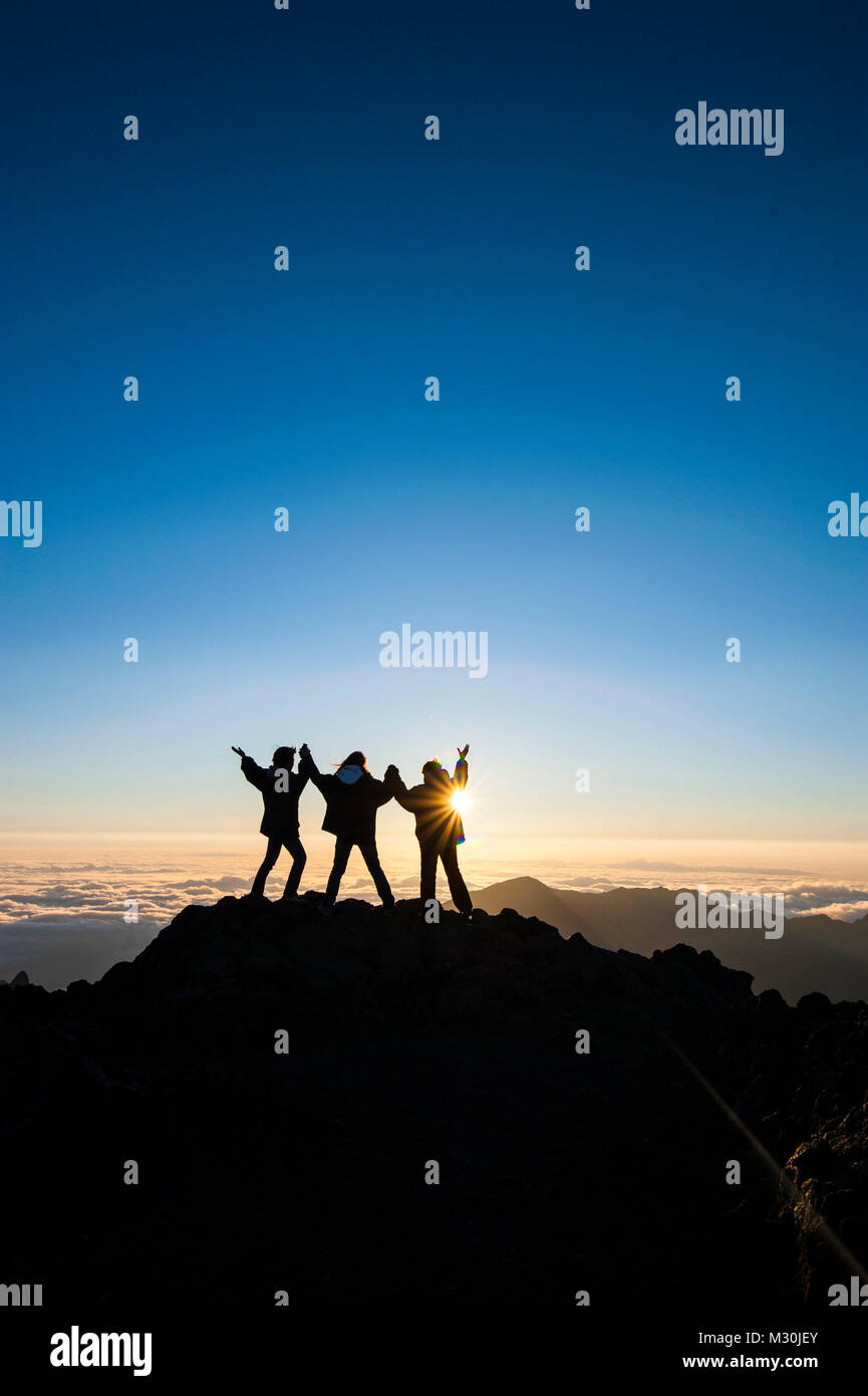 I turisti in attesa di retroilluminazione per il tramonto sulla cima di Haleakala National Park, Maui, Hawaii Foto Stock