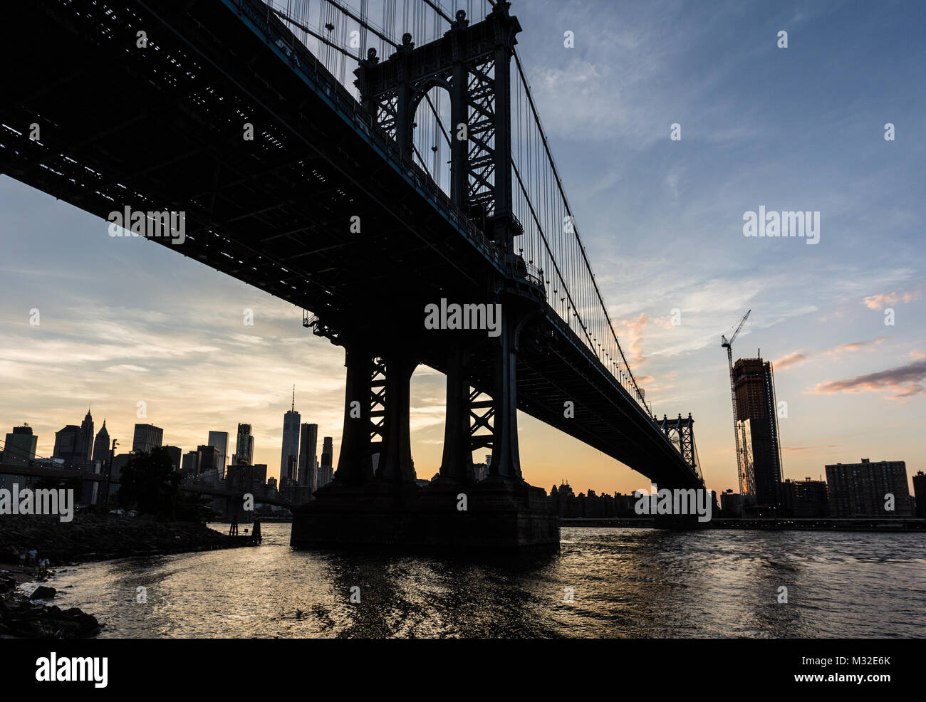Tramonto mozzafiato su Manhattan Bridge e il Manhattan il quartiere finanziario in tutta l'East River da Brooklyn a New York City, Stati Uniti d'America Foto Stock