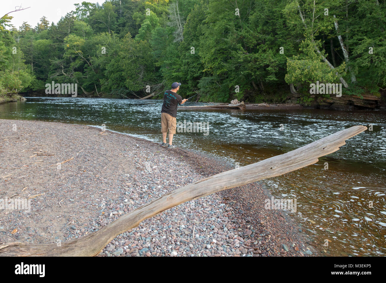 Wakefield, Michigan - un uomo pesci in Presque Isle fiume in contrada deserto montagna parco dello stato. Foto Stock