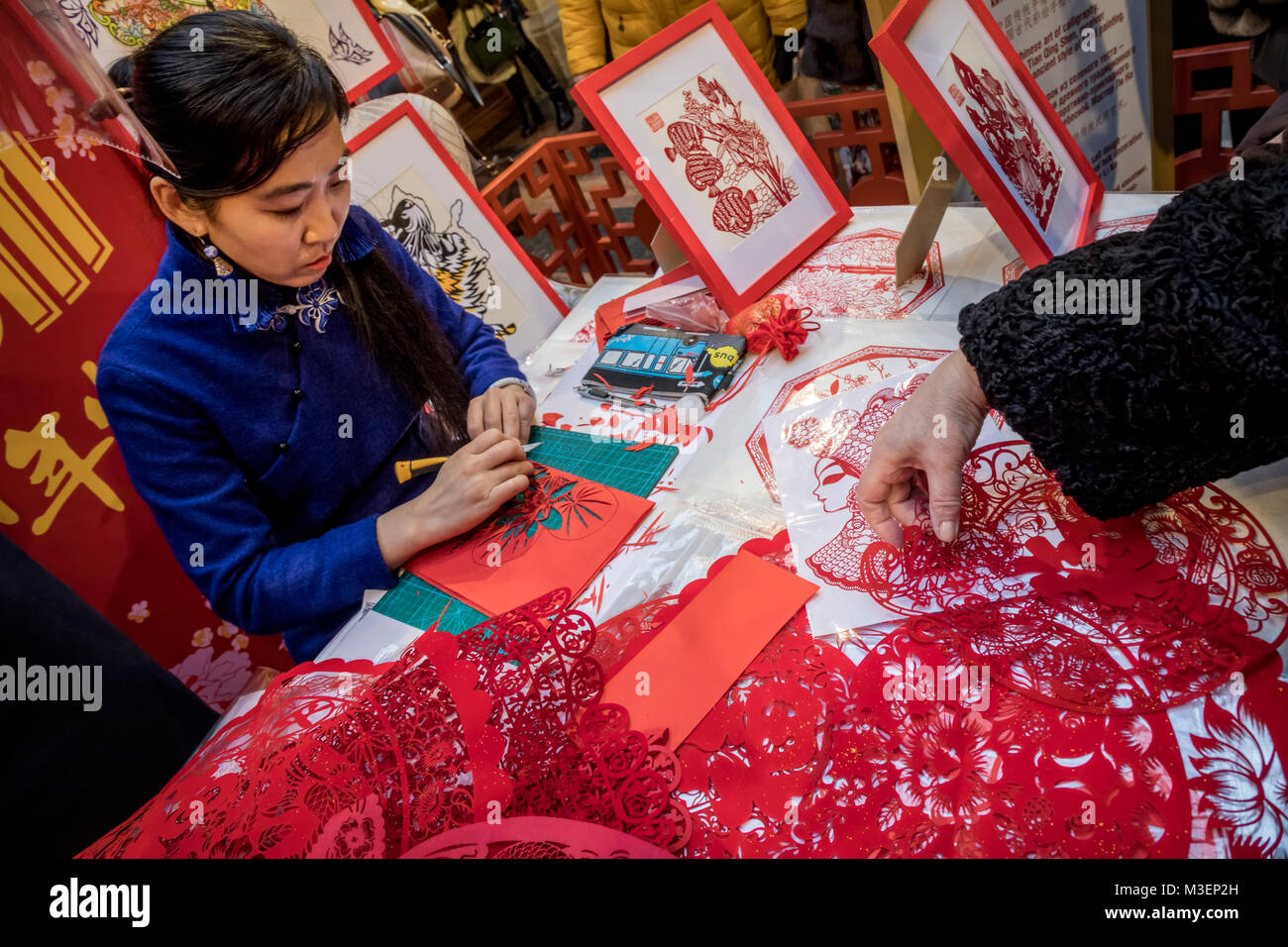 Un maestro cinese è impegnato in Jianzhi folk art - folk tradizionale cinese decorativo il taglio della carta Foto Stock
