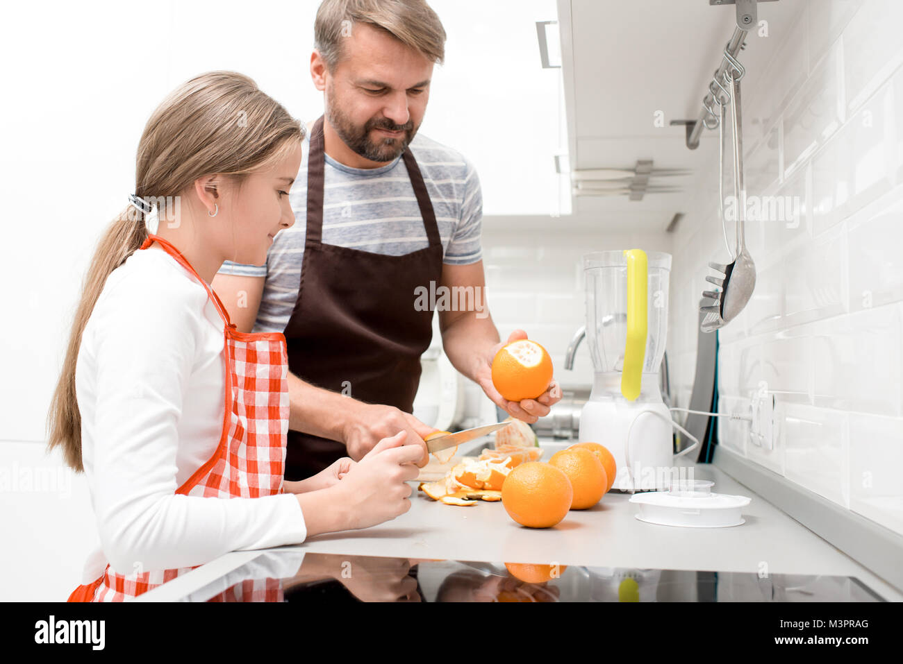 Padre cucinare con la ragazza adolescente Foto Stock