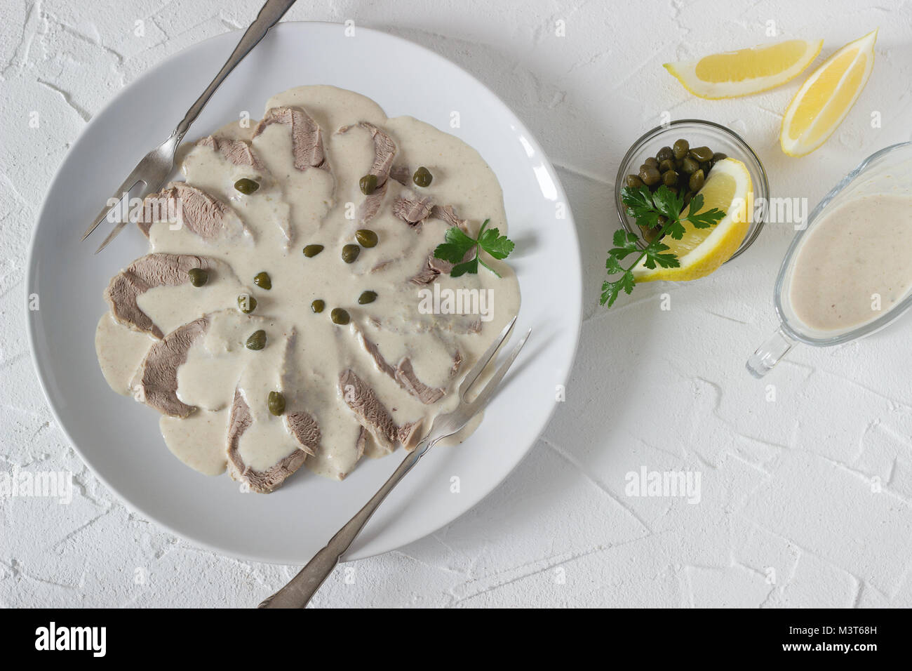 Vitello tonnato è un tradizionale piatto italiano su un cemento bianco sullo sfondo. Messa a fuoco selettiva. Foto Stock