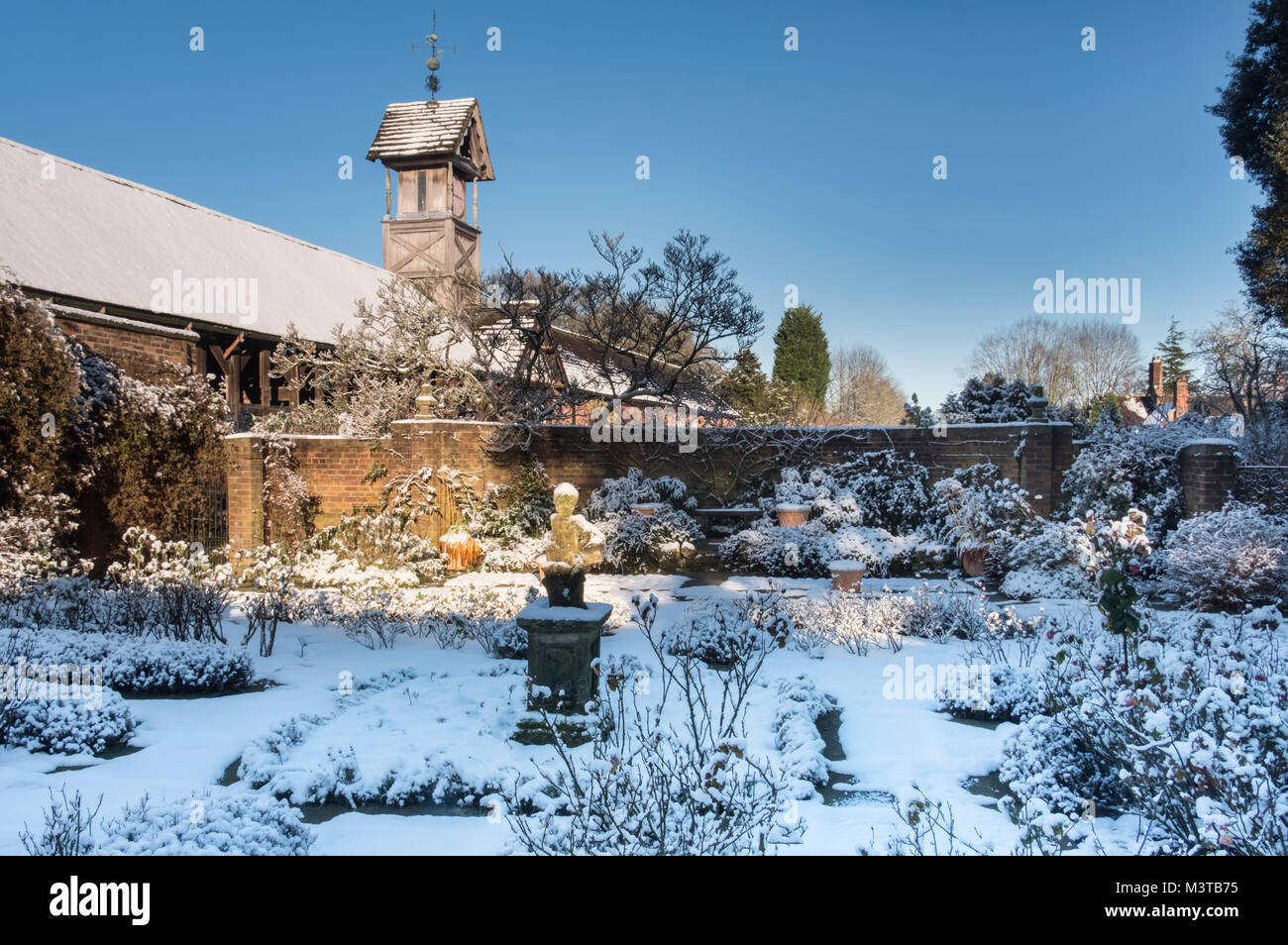Il Fienile Cruck e Torre dell Orologio da bandiera giardino in inverno, Arley Hall, Arley, Cheshire, Inghilterra, Regno Unito Foto Stock