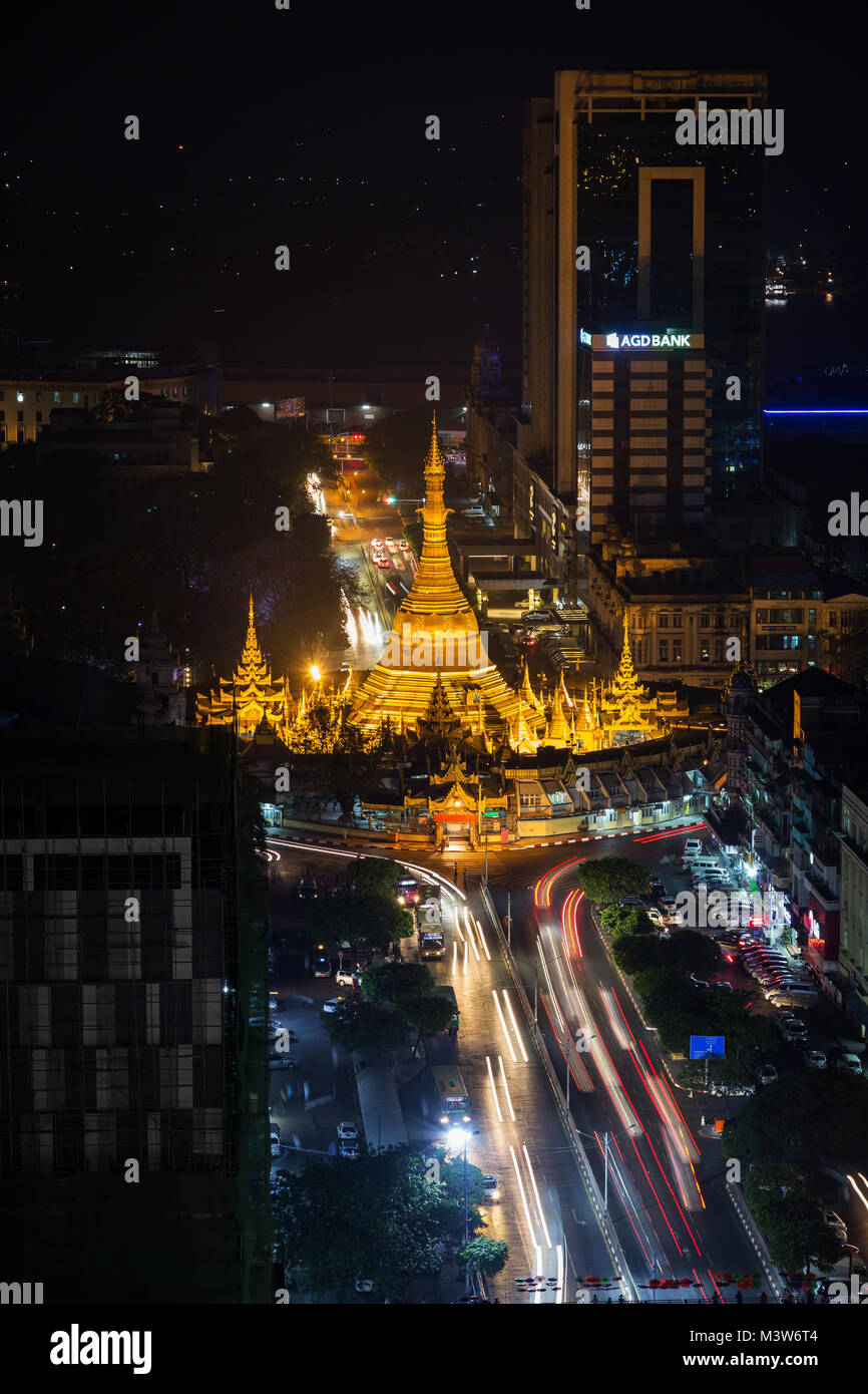 Downtown, Sule Pagoda Road e illuminato Sule Pagoda di Yangon, Myanmar, visto da sopra la sera. Foto Stock