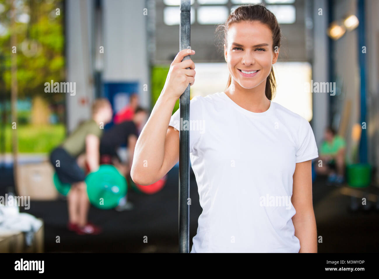 Donna sorridente atleta che indossa Tshirt bianco nel Club Salute Foto Stock