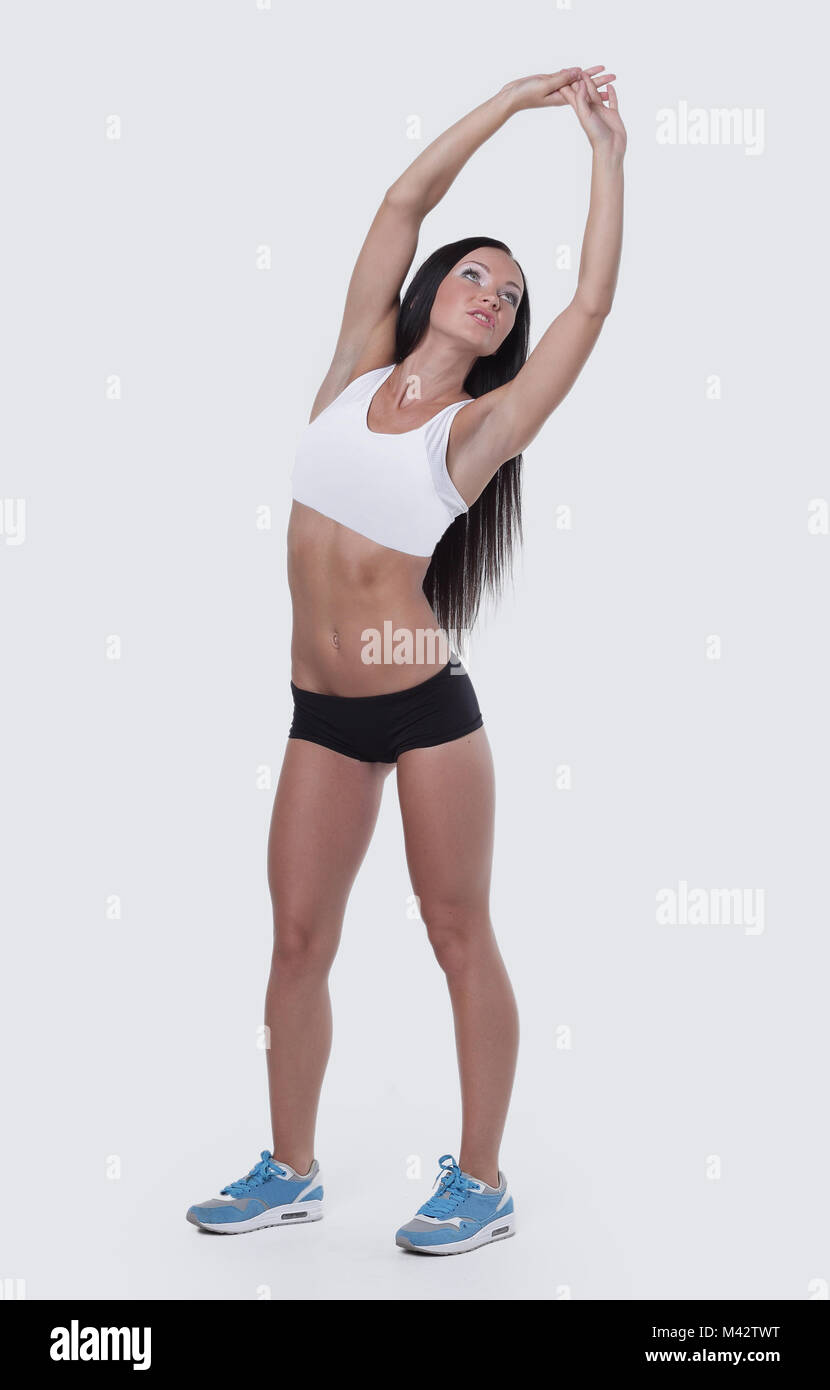 Donna con le braccia sollevate, facendo esercizi di stretching Foto Stock
