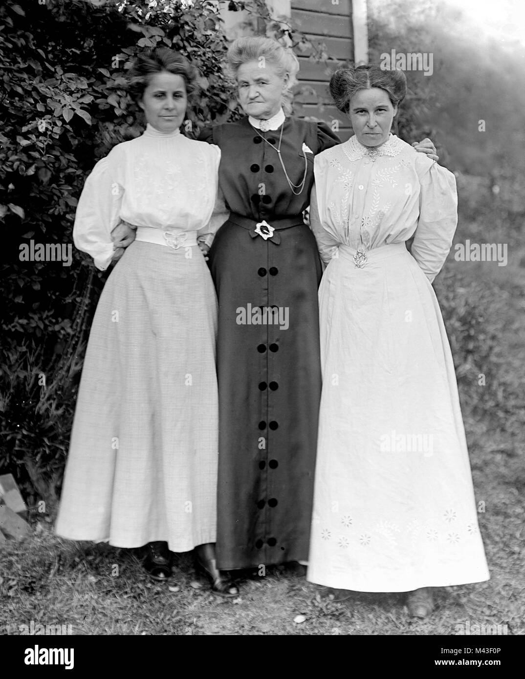 Senior madre pone con i suoi due figli adulti, ca. 1910. Foto Stock