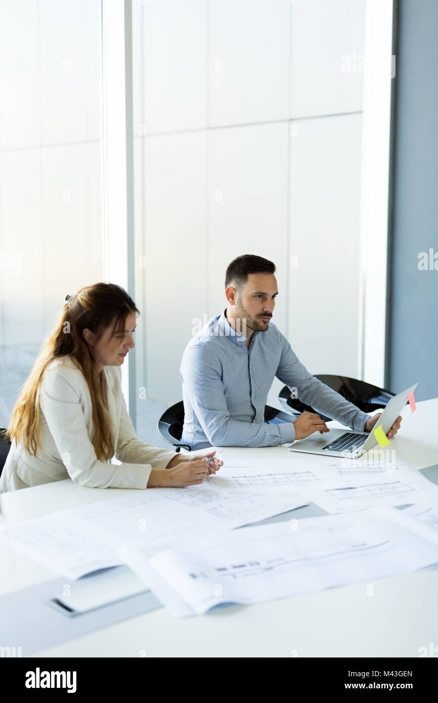 Team di architetti che lavorano su piani di costruzione Foto Stock