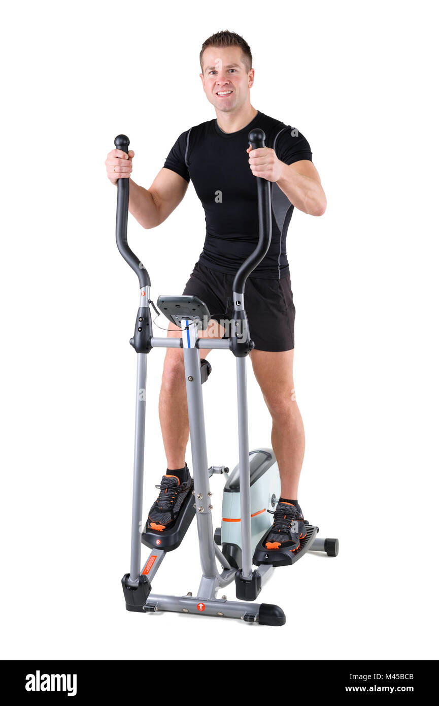 Giovane uomo facendo esercizi sul trainer ellittico Foto Stock