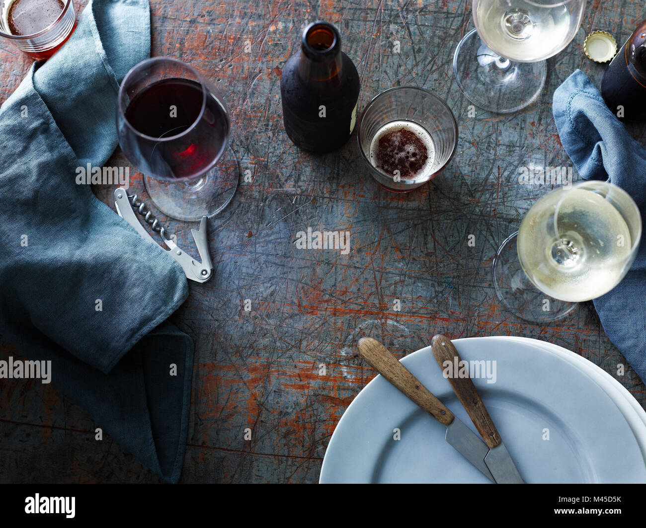 Le bottiglie di birra con il vino bianco e rosso bicchieri sul tavolo, vista aerea Foto Stock