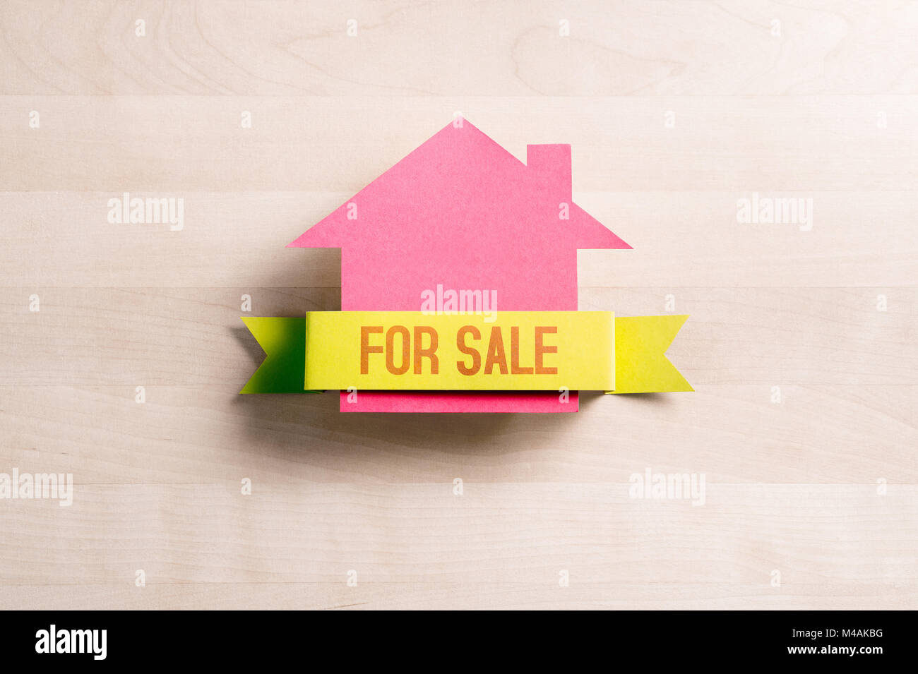 Casa in vendita. Immobili business concetto. Vendita e acquisto di casa. Cottage di cartone carta sul tavolo di legno. Foto Stock