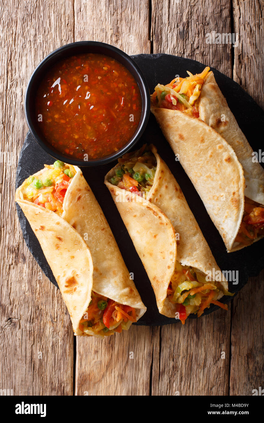 Indian veg Primavera Rotolo farcito con vari ortaggi vicino sul tavolo. Verticale in alto vista da sopra Foto Stock