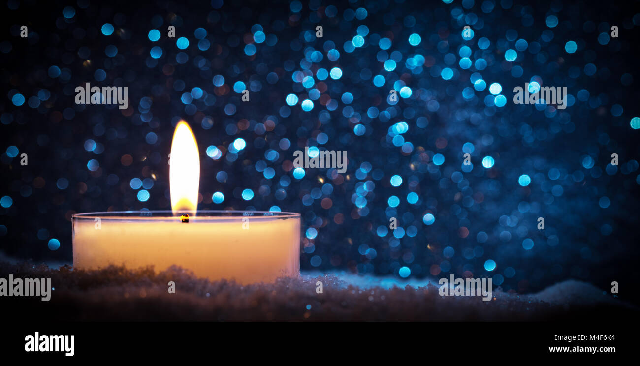 Chistmas candela incandescente su sfondo glitter. Foto Stock