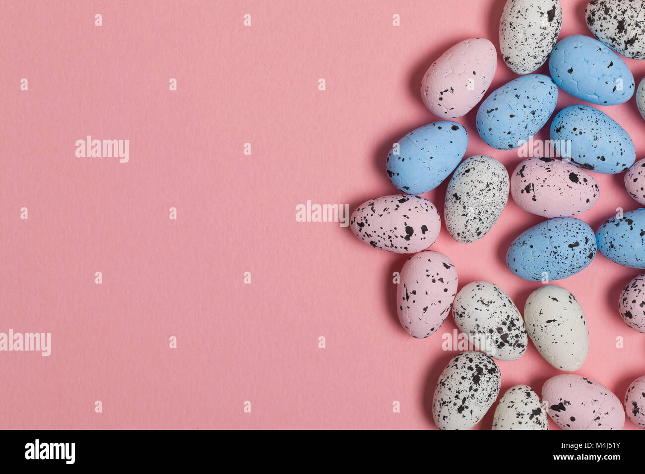 Una collezione di uova di pasqua su un pastello sfondo rosa Foto Stock
