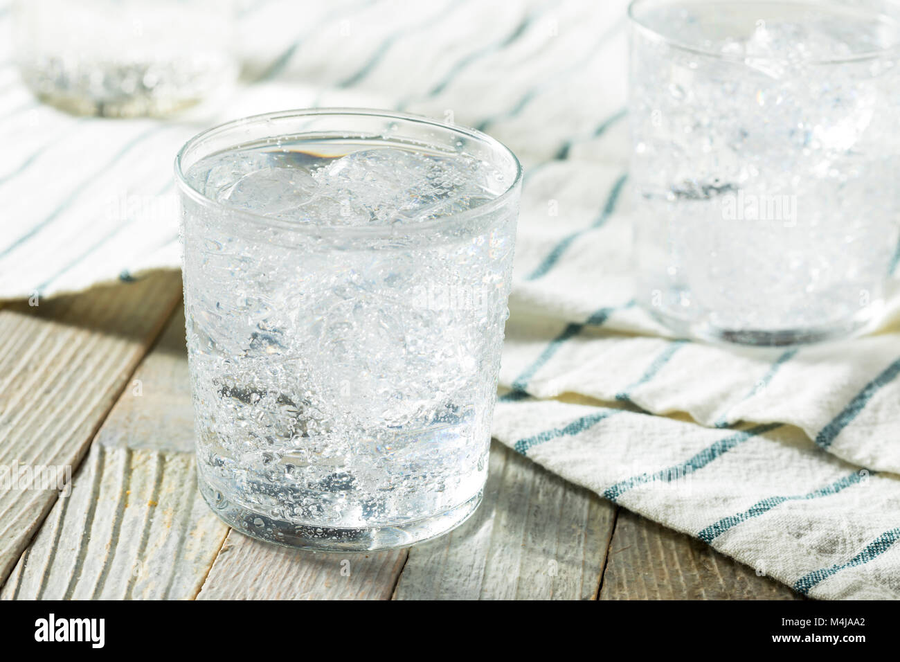 Molla di fresca acqua frizzante con il ghiaccio in un bicchiere Foto Stock