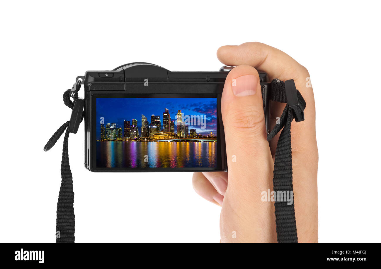 Mano con fotocamera e Singapore skyline della città (la mia foto) Foto Stock