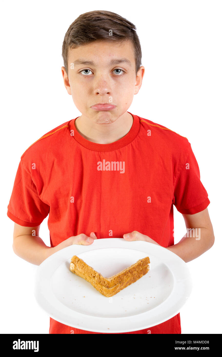 Giovani caucasici ragazzo adolescente non piace croste a sandwich Foto Stock