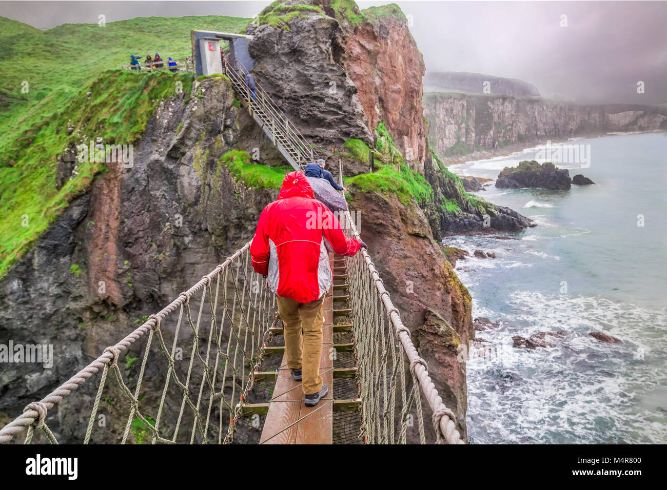 Carrick a rede ponte di corde è un famoso ponte di corde in Irlanda del Nord.it si estende per 20 metri (66 ft) e 30 metri (98 ft) sopra le rocce di seguito. Foto Stock