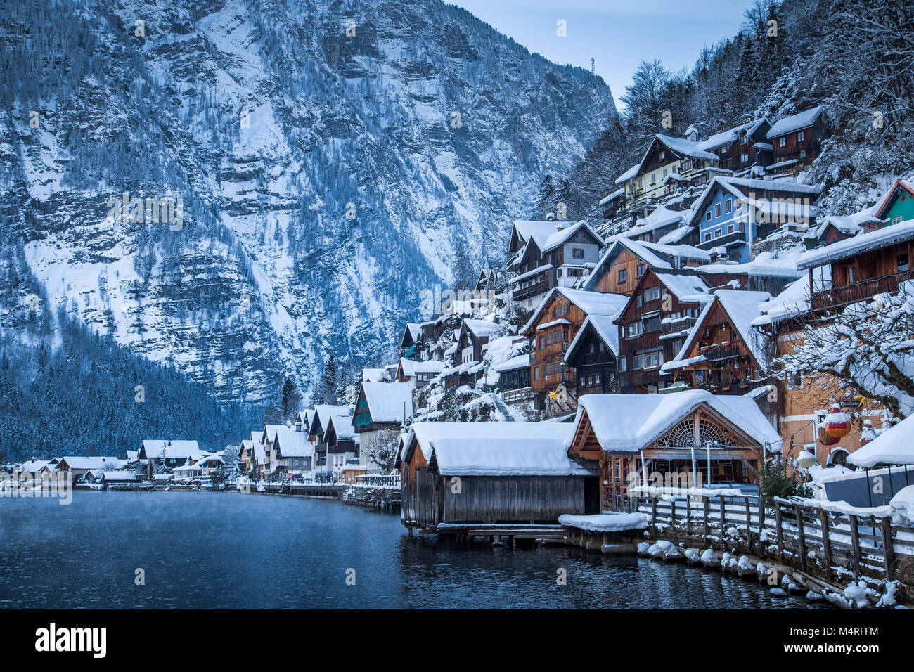 Classic vista da cartolina di tradizionali case di legno nella famosa Hallstatt Lakeside Town nelle Alpi nel crepuscolo mistico durante il blu ora di notte, Austria Foto Stock