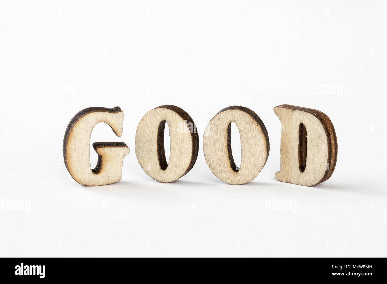 Buona, legno lettere buone su sfondo bianco Foto Stock