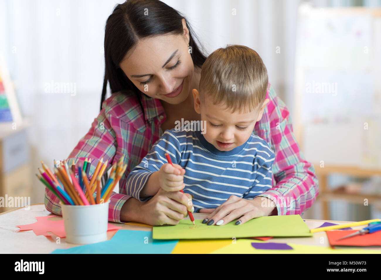 Insegnante di disegno di Donna con bambino ragazzo in aula Foto Stock