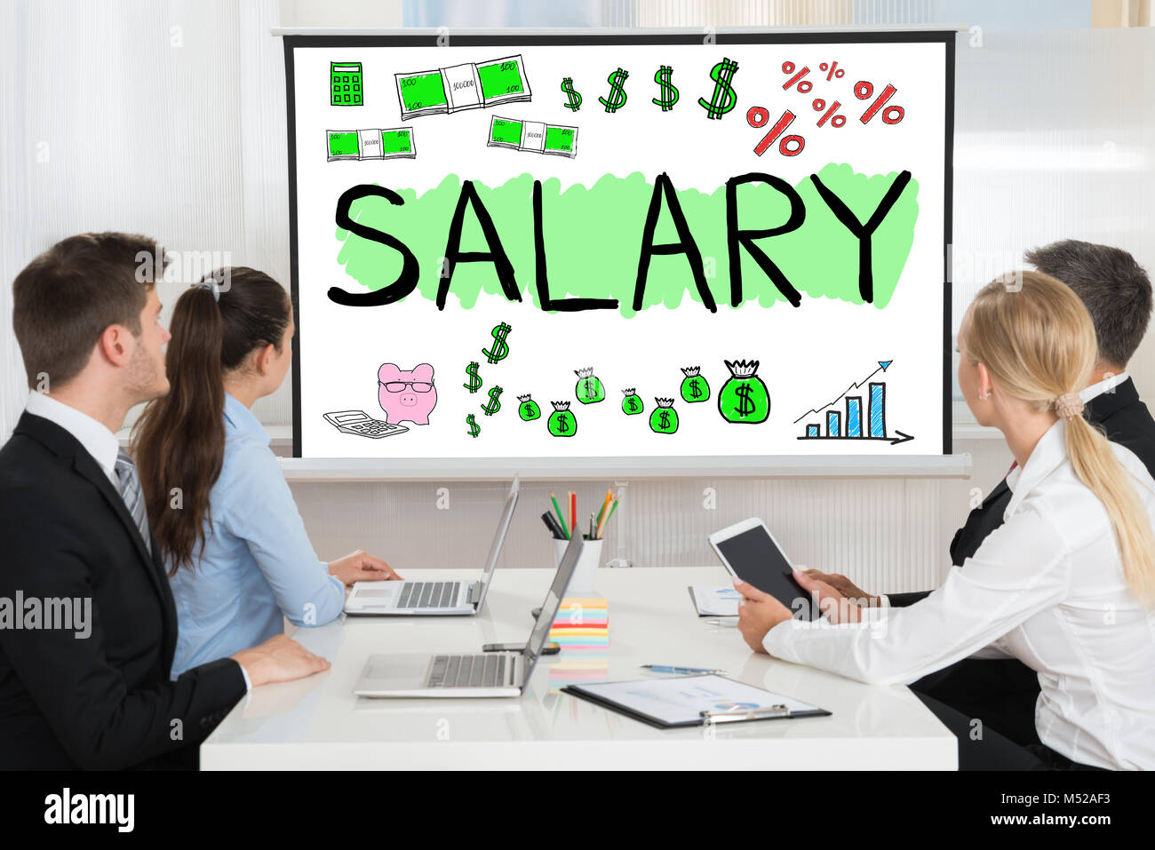 Gruppo di persone che guardano la presentazione di stipendio Foto Stock