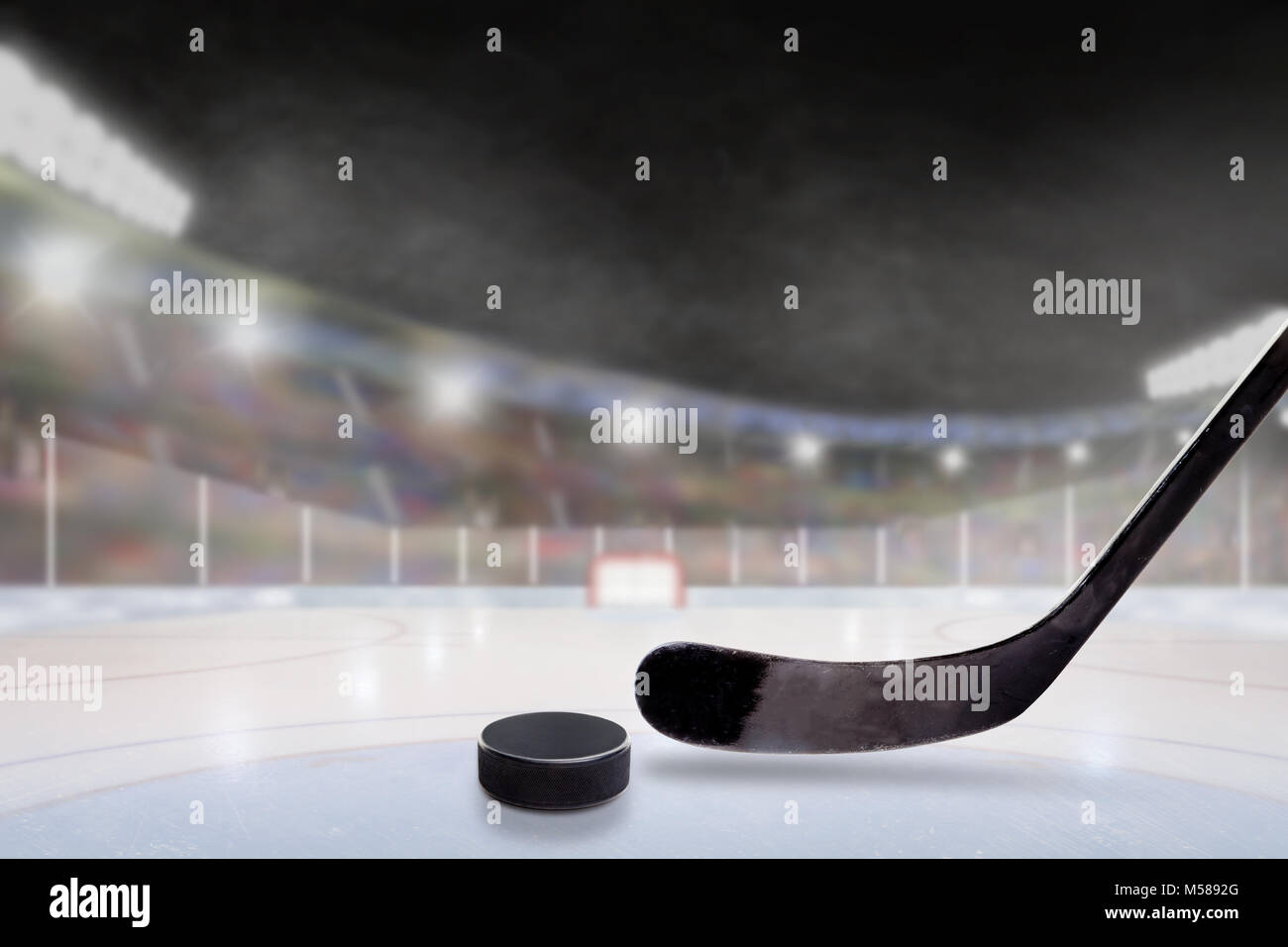 Hockey su ghiaccio la memory stick e puck in luminose outdoor stadium con focus sul primo piano e profondità di campo sullo sfondo. La deliberata lens flare e Foto Stock