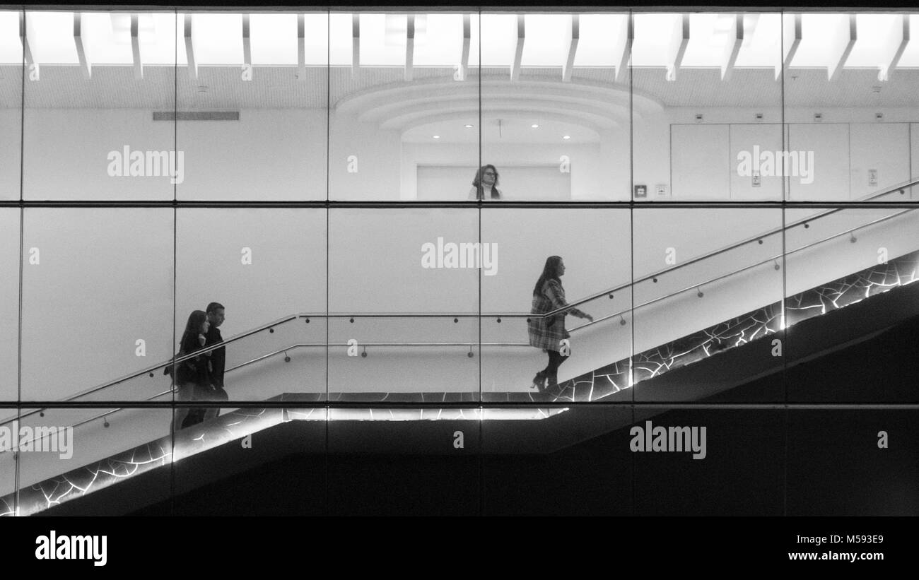 Peeking su peep finestra di vetro con persone salendo le scale Foto Stock
