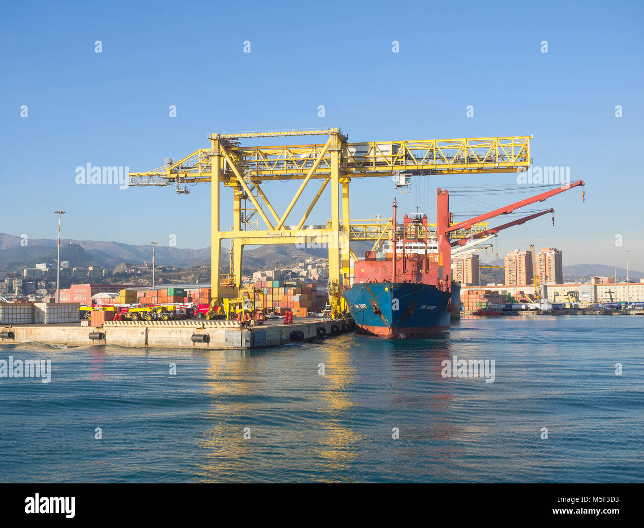 Genova , Italia   23 dicembre 2017: navi cargo caricato da grande gru giallo nella porta Foto Stock