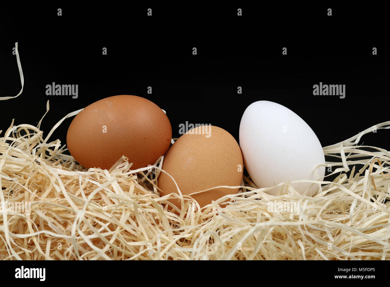 Tre uova con lana di legno Foto Stock