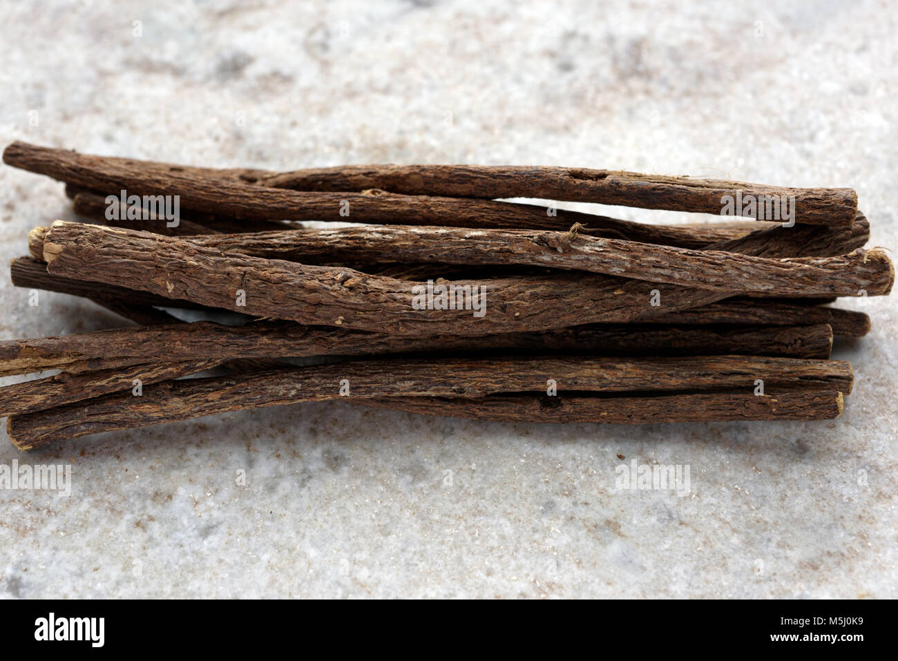 Mazzetto di bastoncini di liquirizia su un marmo tagliere Foto Stock