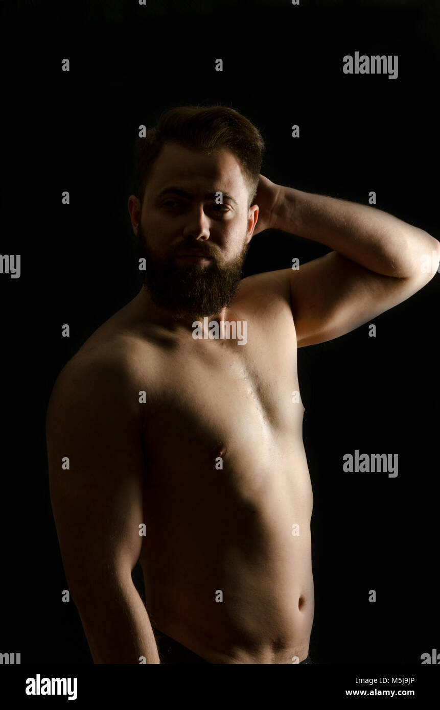 Shirtless, bel giovane uomo in piedi. Studio shot di luce, Foto Stock