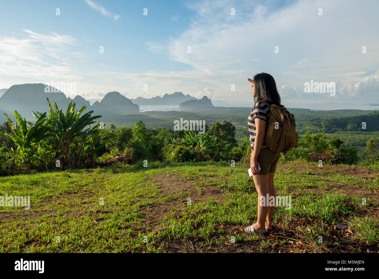 Giovane viaggiatore backpacker guardando avanti al sole per vedere la vista del paesaggio di montagna all'orario di alba,libertà wanderlust,Khao Samed Nang Chee Viewpoint,P Foto Stock