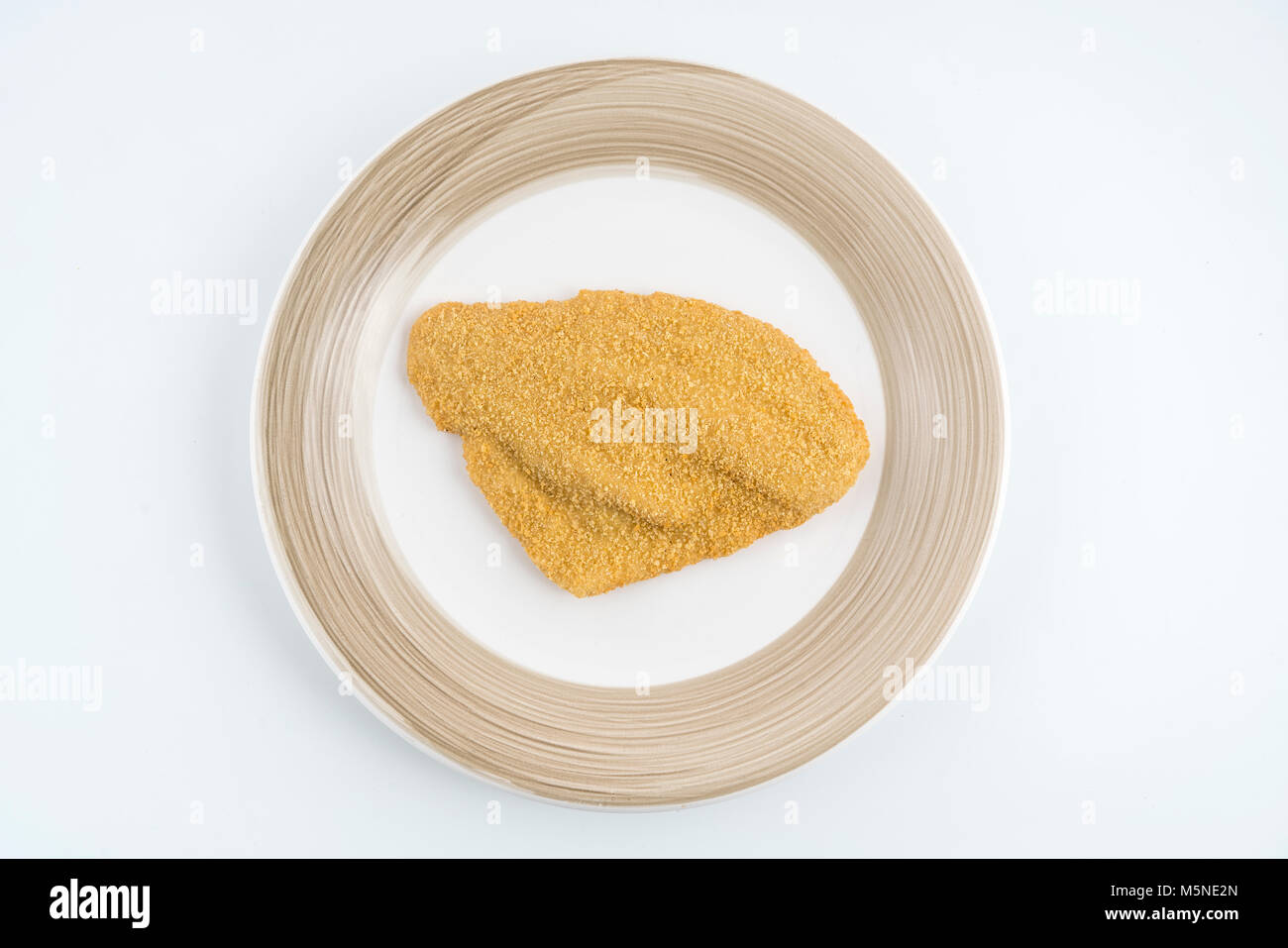 Un filetto di passera di mare impanati surgelati sulla piastra Foto Stock