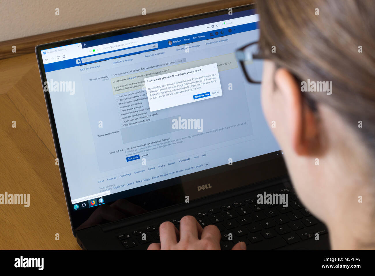 Una donna di uscire il suo account su Facebook - concetto, social media addiction Foto Stock