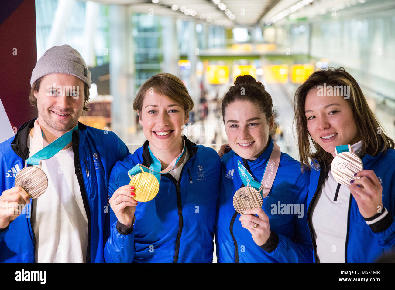 Londra, Regno Unito. Il 26 febbraio, 2018. Team GB vincitori di medaglie Billy Morgan, Lizzy Yarnold, Laura Deas e Izzy Atkin visualizzare le loro medaglie come la British Olympic Association (BOA) benvenuti gli atleti a casa dal Pyeongchang 2018 Giochi Olimpici Invernali presso l'aeroporto di Heathrow. Credito: Mark Kerrison/Alamy Live News Foto Stock