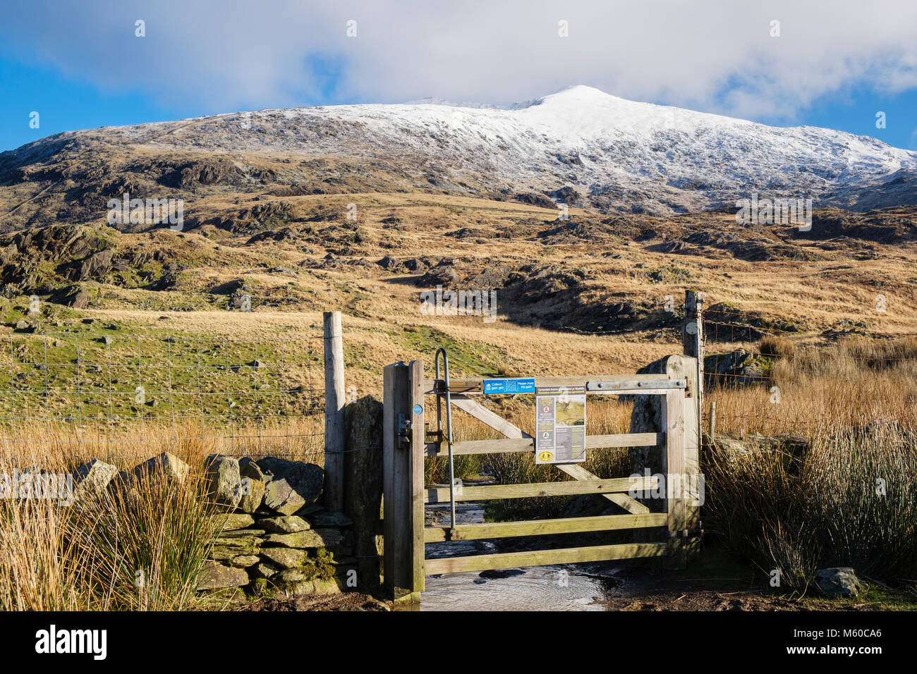 Porta sul sentiero DDU Rhyd con vista sul monte Snowdon innevato in inverno sulle montagne del Parco Nazionale Snowdonia. Rhyd DDU, Gwynedd, Galles del Nord, Regno Unito Foto Stock