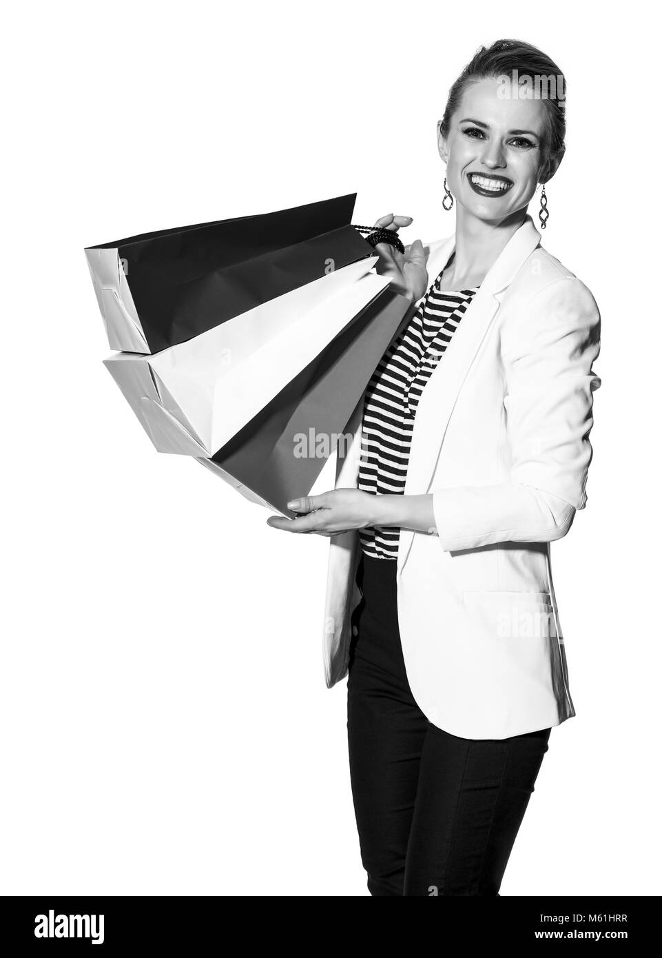 Lo Shopping di lusso. Il modo francese. Ritratto di felice alla moda-monger in camicia bianca isolata su sfondo bianco con le borse della spesa dipinto in th Foto Stock