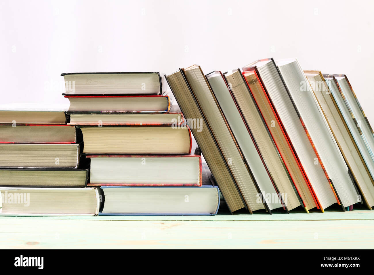 Pila di libri sullo sfondo di legno Foto Stock
