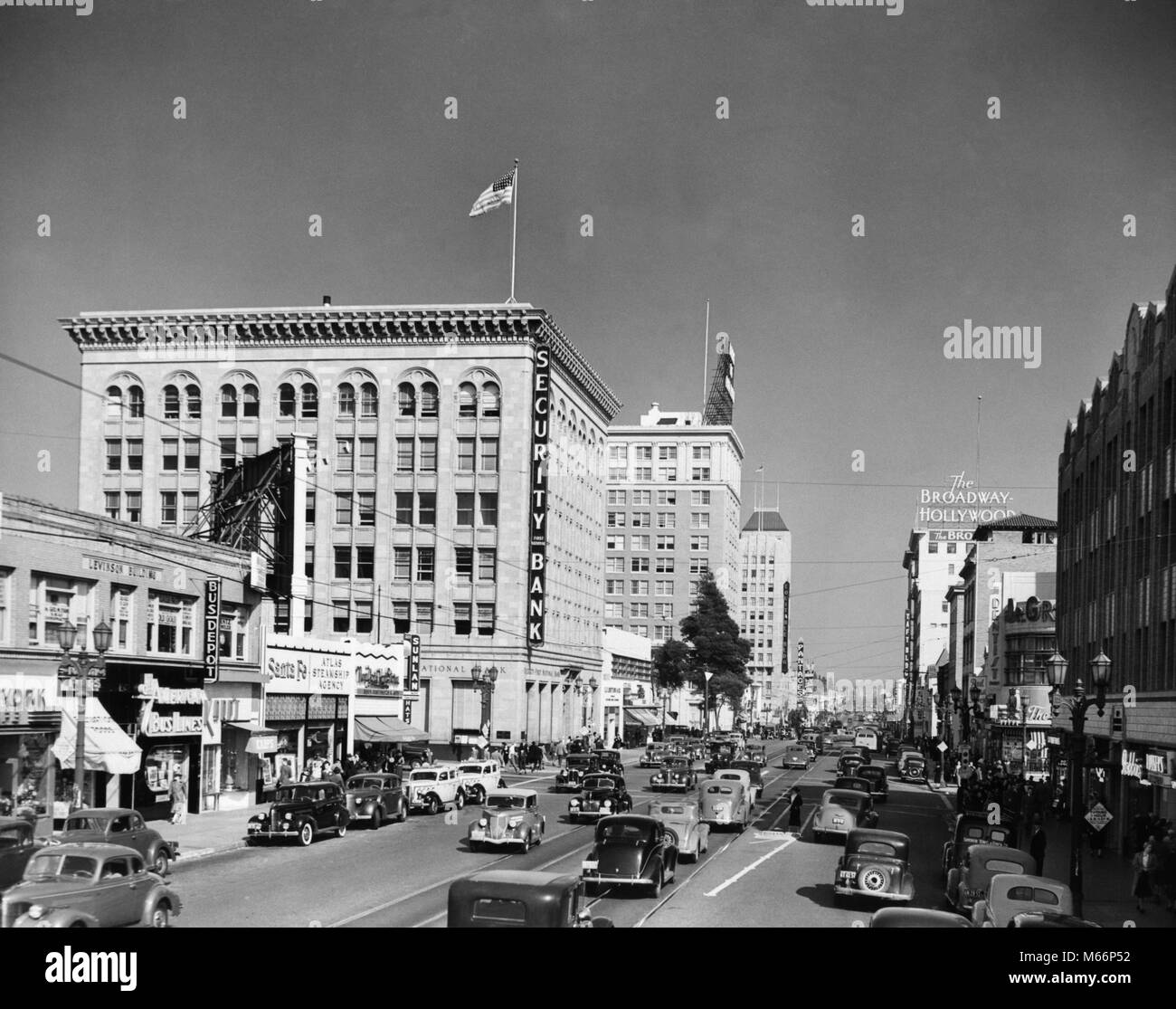 1930s 1940s Street scene guardando ad est da WILCOX ALL HOLLYWOOD BOULEVARD HOLLYWOOD Los Angeles California USA - Q40937 CPC001 proprietà HARS AUTOS EMOZIONE CA REAL ESTATE WEST COAST STRUTTURE Automobili Veicoli edificio congestione bandiera americana B&W IN BIANCO E NERO HOLLYWOOD CALIFORNIA LOS ANGELES in vecchio stile WILCOX Foto Stock