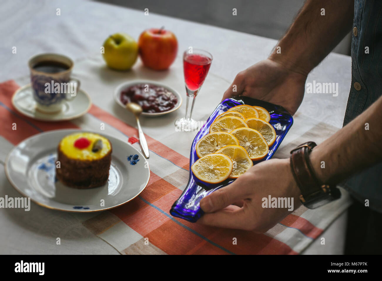 Soltanto le mani. Finitura uomo la sua piastra e quasi pronto a servire a tavola. La decorazione della tavola. Serve piatti. Mangiare in splendidi piatti. Russi Foto Stock