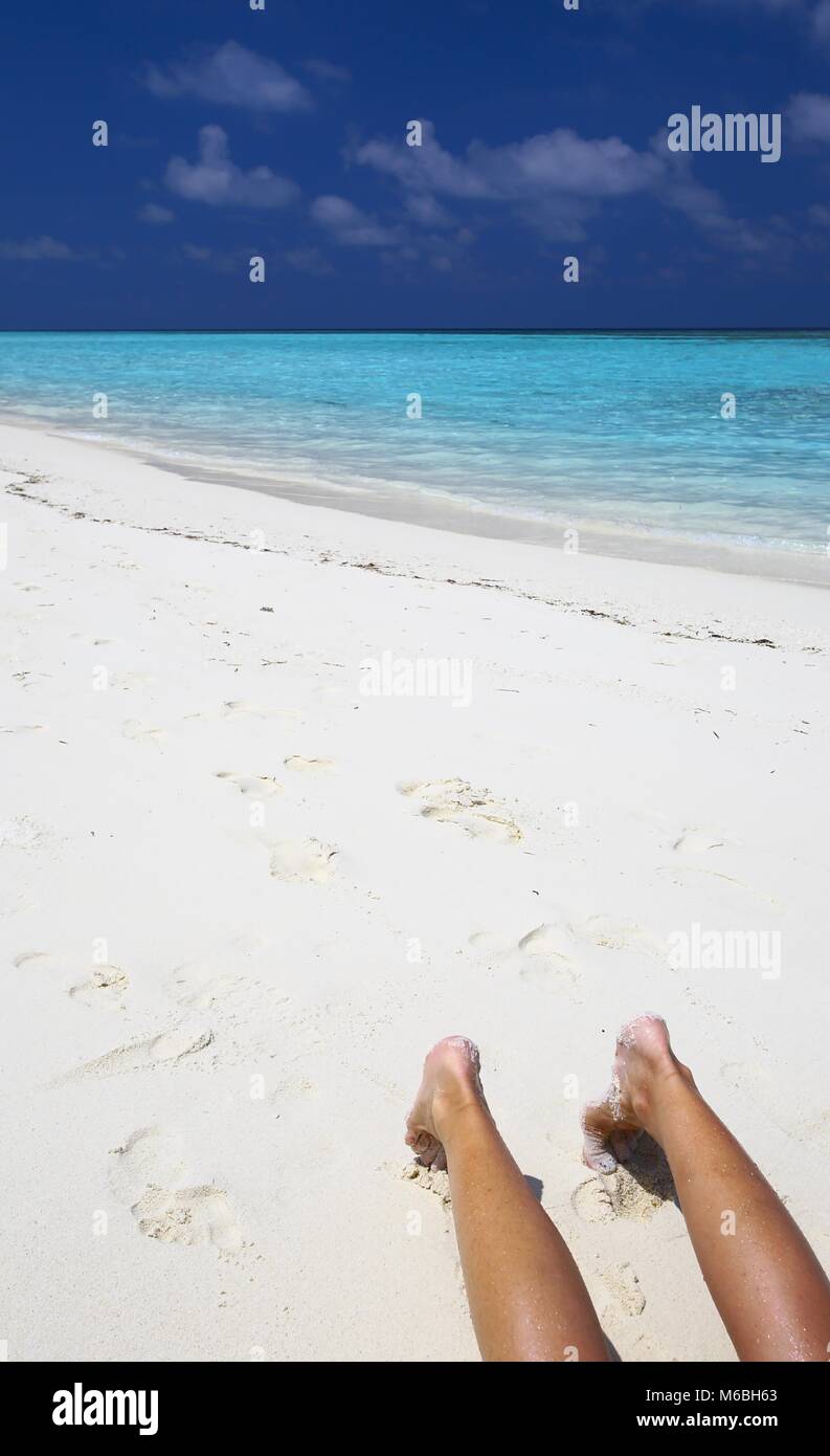 Giovane è sulla spiaggia di sabbia nella giornata di sole Foto Stock