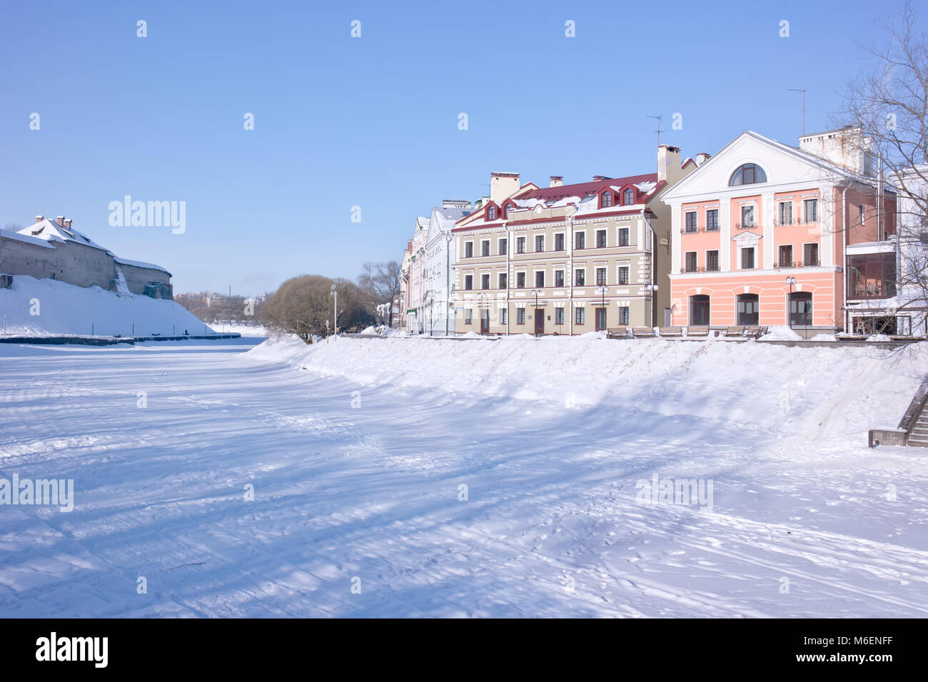 PSKOV, RUSSIA-febbraio 21.2010: Pskova fiume. La torre della fortezza di Pskov e le belle facciate delle case moderne sul terrapieno Sovetskaya Foto Stock